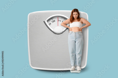 Photos Overweight young sad woman with scales on blue background