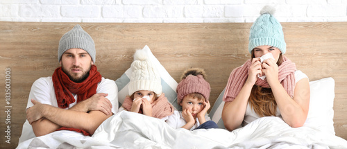 Family ill with flu in bed ...