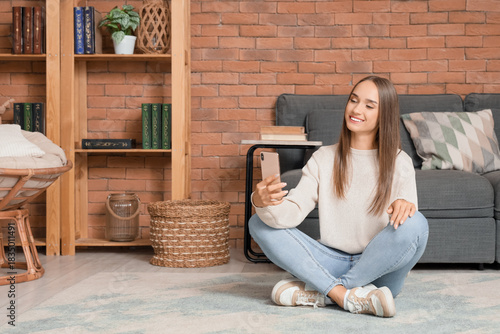 Young woman using mobile ph...