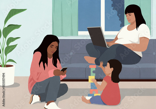 Multiracial females using laptop, smart phone, and playing with toy blocks in living room at night
