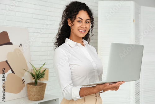 Smiling young woman holding...