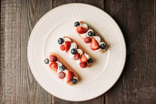 Tiramisu-style dessert with savoiardi, cream cheese and berries. Sweets and desserts.
