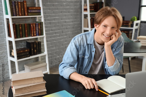 Male student studying at ta...