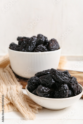 Dried prunes in white ceram...