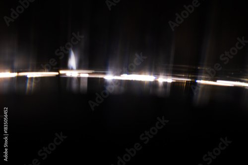Lens Flare. Light over black background. Easy to add overlay or screen filter over photos. Abstract sun burst with digital lens flare background. Gleams rounded and hexagonal shapes.