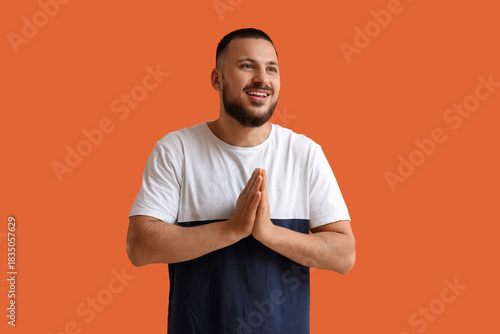 Thankful young man pressing...