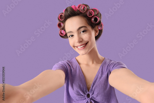 Young woman with hair curle...