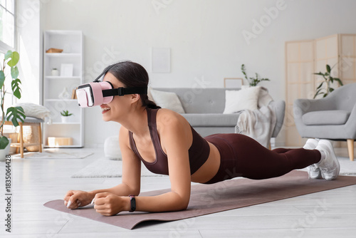 Sporty young woman in VR gl...