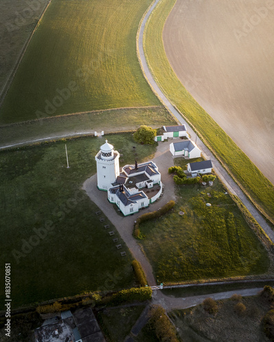 Aerial view of the South Foreland Lighthouse standing proudly amidst the verdant fields and dramatic coastline, a beacon of history and maritime heritage, Dover, England, United Kingdom.