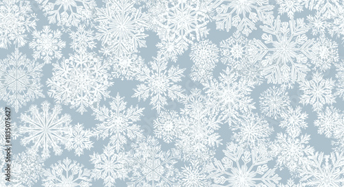 Snowflakes on a soft blue background in a winter pattern  