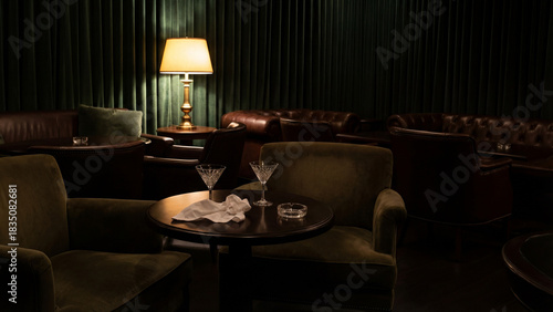 An elegant, dimly lit speakeasy or lounge bar with two martini cocktails on a table. Retro interior with dark green walls, velvet armchairs, and soft lamp light.