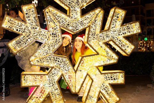 Gen z girls celebrating christmas shopping in valencia