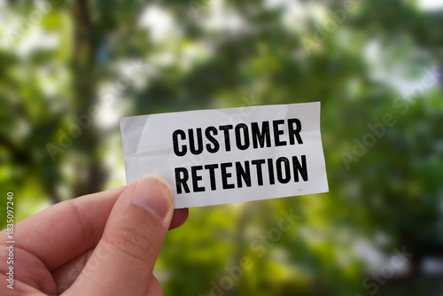 Customer Retention message written on ripped torn paper background. Conceptual Customer Retention symbol. Copy space.