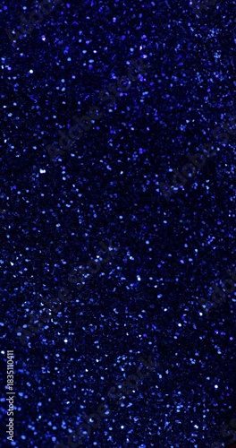 Deep Blue Glitter Texture. Sparkling dark navy blue glitter background with subtle shimmering movement.