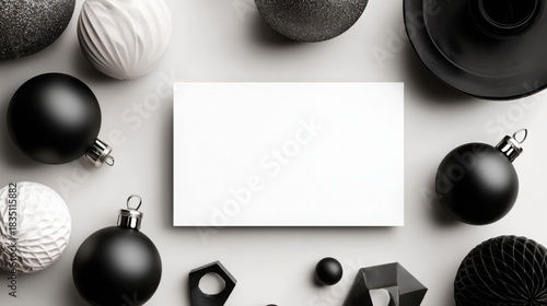 Horizontal A5 greeting card mockup in minimalist modern Christmas flat lay with monochrome ornaments, geometric shapes and sleek black-and-white dÃ©cor