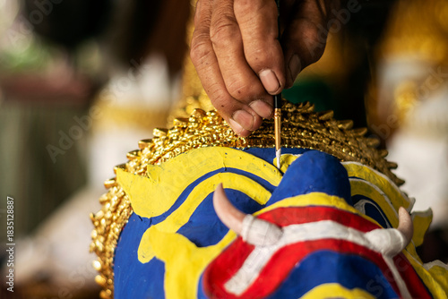 close up of artist painting lakhon khol traditional mask in cambodia