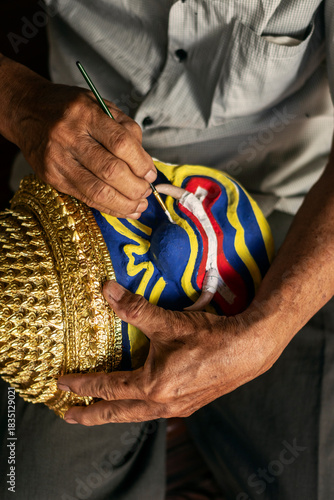 close up of artist painting lakhon khol traditional mask in cambodia