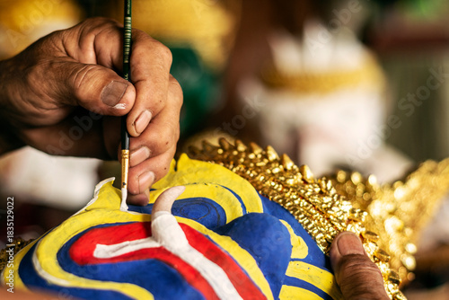 close up of artist painting lakhon khol traditional mask in cambodia