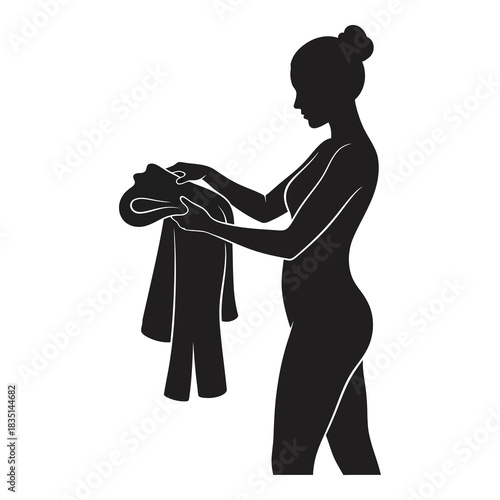 Elegant woman drying her face with a towel after shower for skincare routine