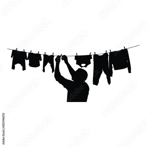 Man hanging laundry out to dry on clothesline in silhouette against white