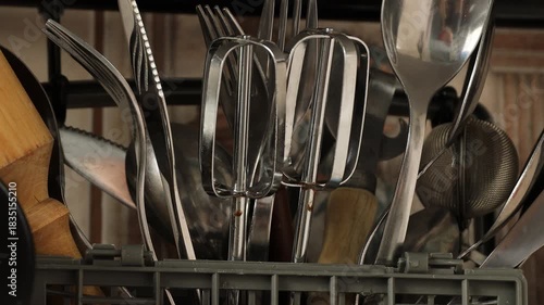 A collection of kitchen utensils arranged neatly in a wicker basket