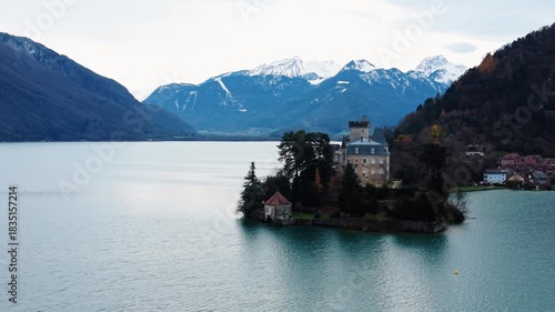 Aerial view of Chateau de Duingt, a historic castle on a small island in the serene Lake Annecy, surrounded by mountains, Duingt, Auvergne-Rhone-Alpes, France.