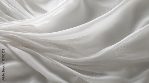 Elegant white fabric with smooth wavy folds. Light grey cloth texture as background for design. Concept of luxury material or soft natural textile. Trend color year 2026.