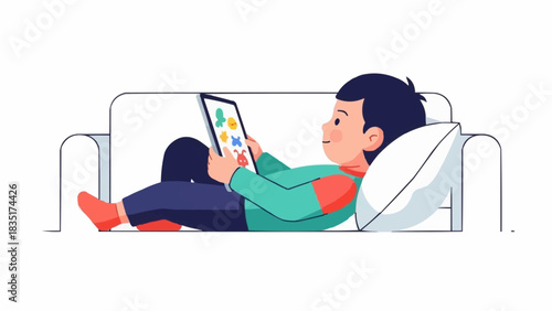 Boy Relaxing on Couch with Tablet Device.
