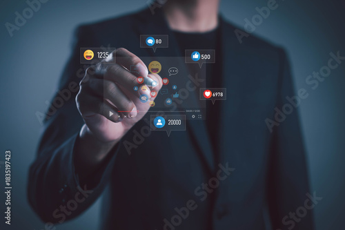 businessman interacting with floating social media icons represents digital marketing engagement, online communication, audience growth, modern networking in a technology-driven business environment.