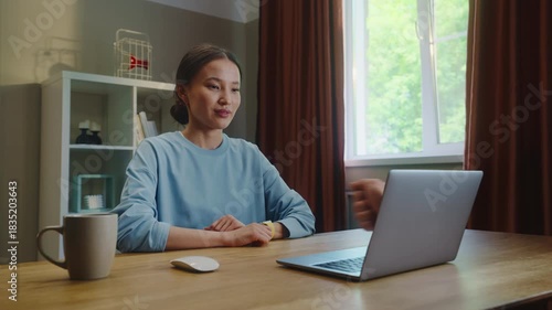 Asian woman see thump up remotely, thumbup like ok from laptop screen. Approval at home. Female employee virtual meeting. Successful distant interview. Girl good job video call. Work deal conference.