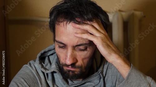A worried man is sitting on the floor. Depression Drug addiction Alcohol addiction Mental disorder. unemployment, despondency, loneliness, disappointment, decline, bad news