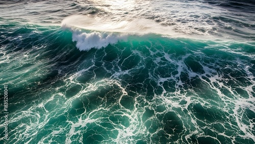Fototapeta Naklejka Na Ścianę i Meble -  Crashing ocean wave with sunlight turquoise water and white foam dynamic sea surface for travel and 