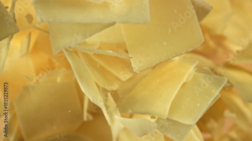 Super slow motion Parmesan cheese on a light background. Filmed on a high-speed camera at 1000 fps. High quality FullHD footage