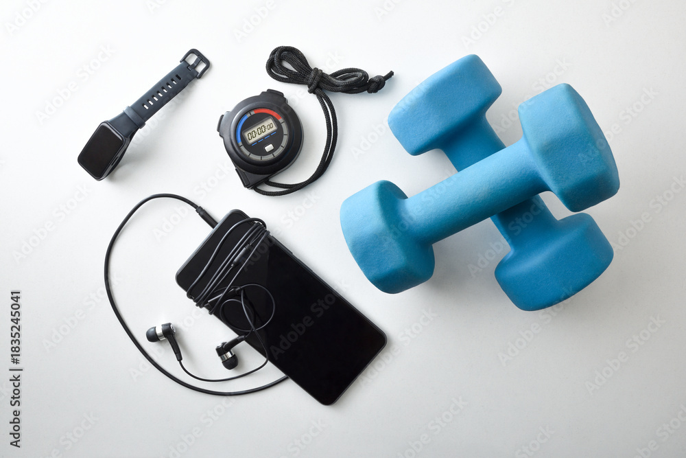 Fototapeta premium Sports equipment with dumbbells and electronic devices