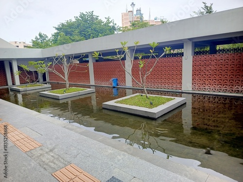 Modern reflection pool courtyard with geometric wall