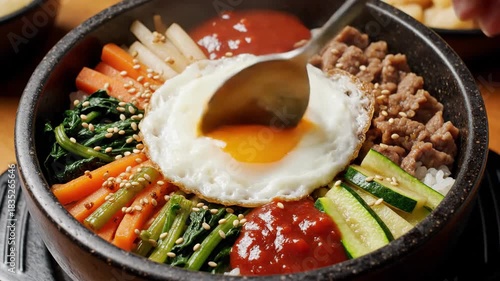 Bibimbap Delight - A Korean Rice Bowl with Vibrant Vegetables and Egg.