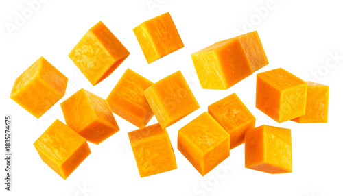 Fresh diced butternut squash or pumpkin pieces falling and scattered, isolated on a white background