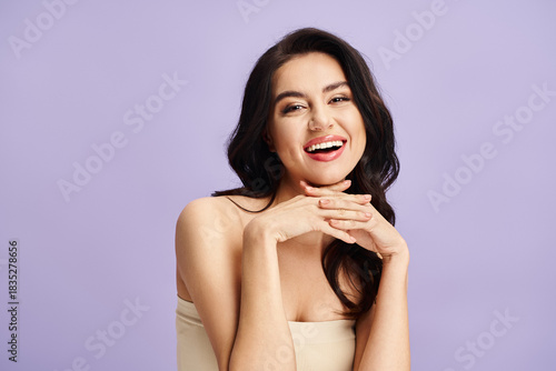 Fotografie Young beautiful woman sharing a radiant smile against a lovely pastel backdrop