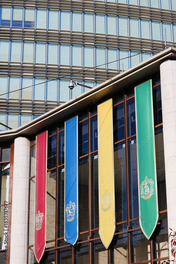 Fototapeta premium TOKYO, JAPAN - November 30, 2025: Hogarts school house banners on 'Harry Potter Plaza' in Akasaka.