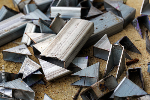 Metal scrap after cutting process, industrial waste, close-up of sharp metal scraps.