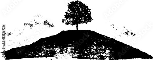 Black and white landscape silhouette of lone tree on hill for artistic design