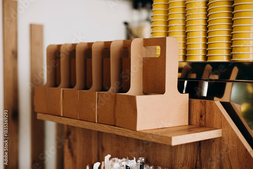 Photos Close-up of cardboard coffee carriers holding takeaway drinks.