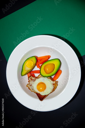 fried eggs with avocado and vegetables