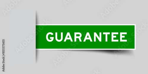 Green color square shape sticker label with word guarantee inserted in gray background