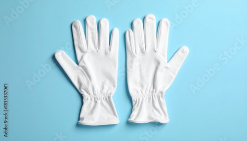 Wallpaper Mural White Fabric Gloves with Gathered Cuffs on Light Blue Surface Torontodigital.ca