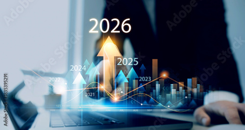 Businessman analyzing financial growth chart for 2026 year.Showing revenue increase, market trends, investment strategy, economic progress, success and future business development in 2026	

