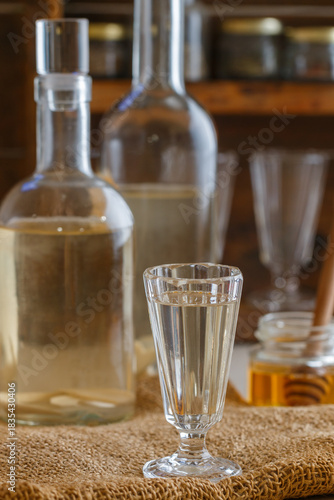 Horseradish tincture. Homemade strong alcoholic drink with horseradish and honey. Bitter. Rustic style. Selective focus
