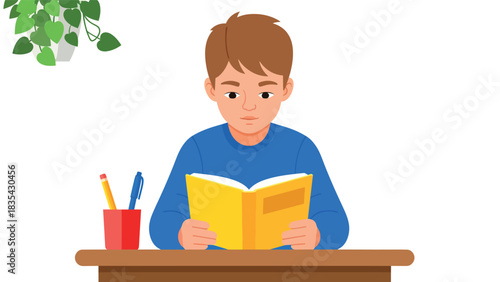 Boy engrossed in reading a book at his desk.