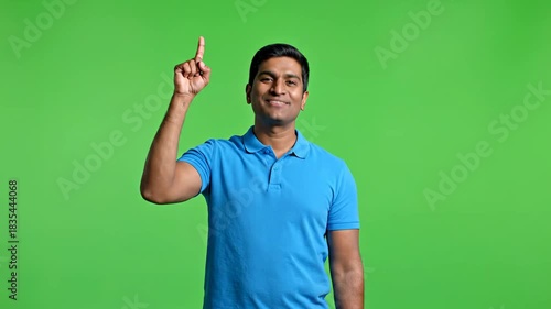 Young Indian man in blue polo shirt showing various hand gestures on a green screen background.