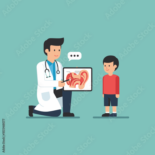 A friendly doctor kneels down to explain the anatomy of the ear to a young boy using a tablet, promoting health and well-being in a medical setting.